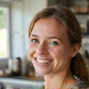 Happy client Emily R. smiling, looking vibrant and healthy after overcoming digestive issues.